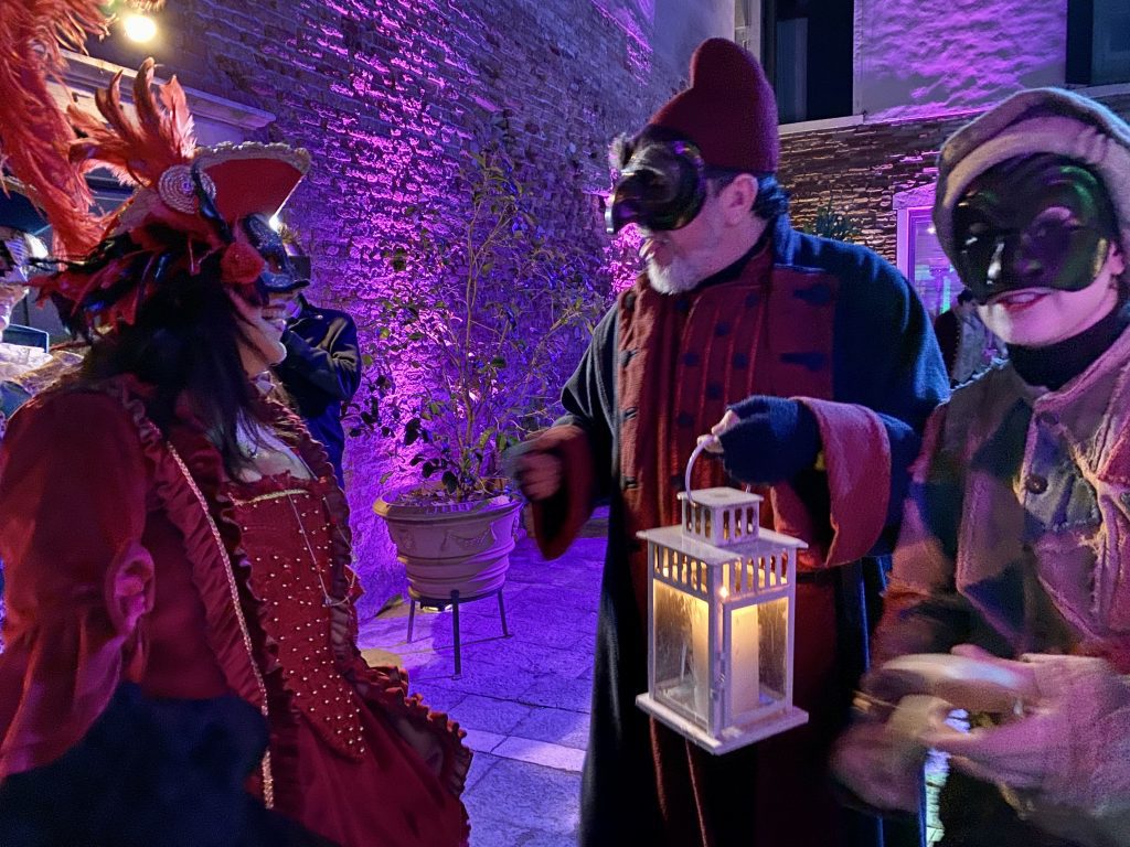 Welcoming guests at a Venice Carnival party